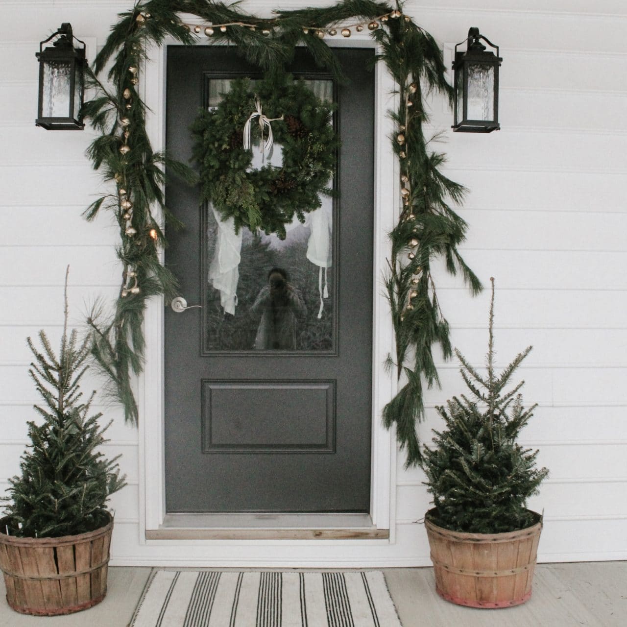Festive Winter Porch Decorated with Jingle Bells and Pine