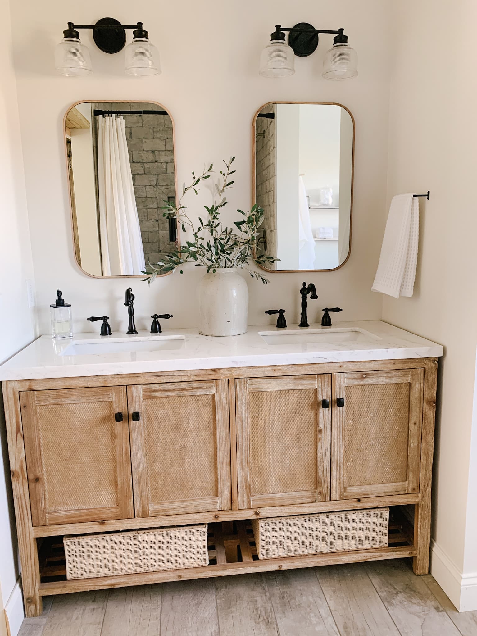 clean and modern bathroom with wooden framed mirrors